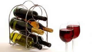 A wine rack full of fun and two glasses of red wine