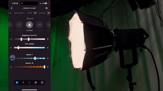 Neewer AS600B video light in a studio next to a screenshot of the companion phone app