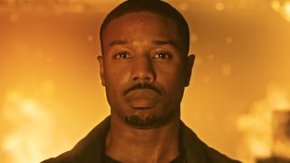 Michael B. Jordan stands in front of a blazing inferno in Fahrenheit 451. 