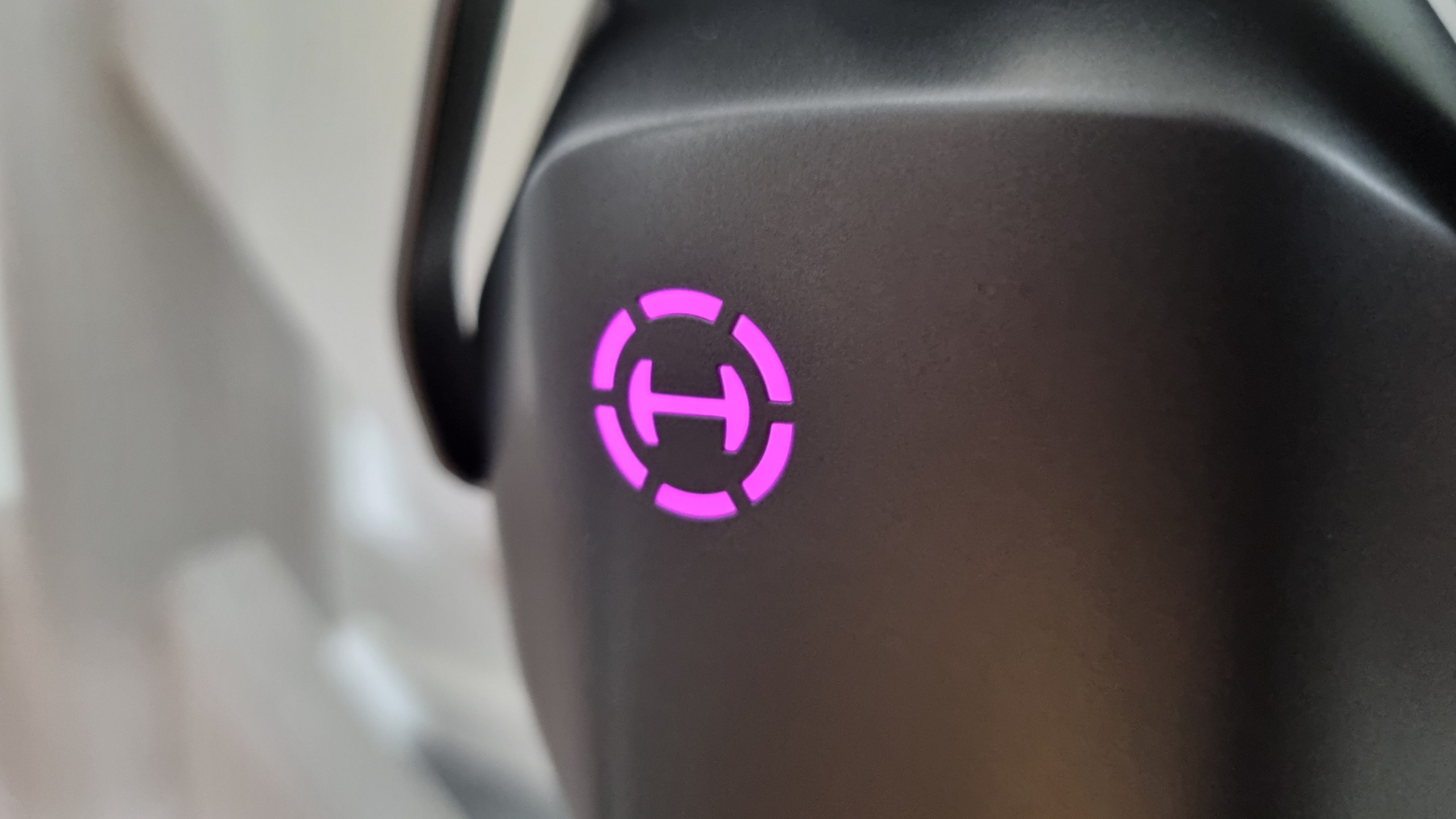 A close up of the RGB-lit Hecate logo on the side of the Edifier G5 Max gaming headset