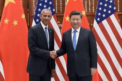 President Xi Jinping (R) shakes hands with US President Barack Obama (L) 