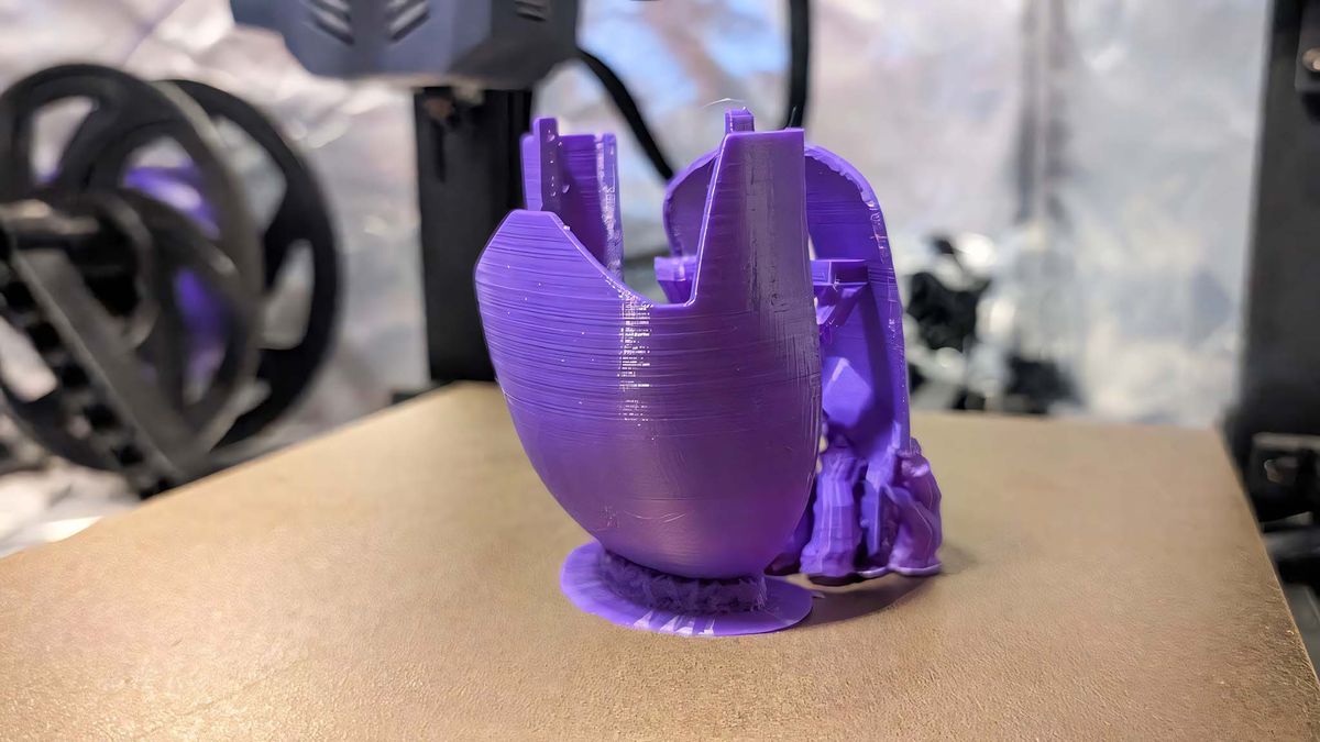 Purple shells 3D printed for HyperX Pulsefire Saga Pro Wireless and still on the printing tray.