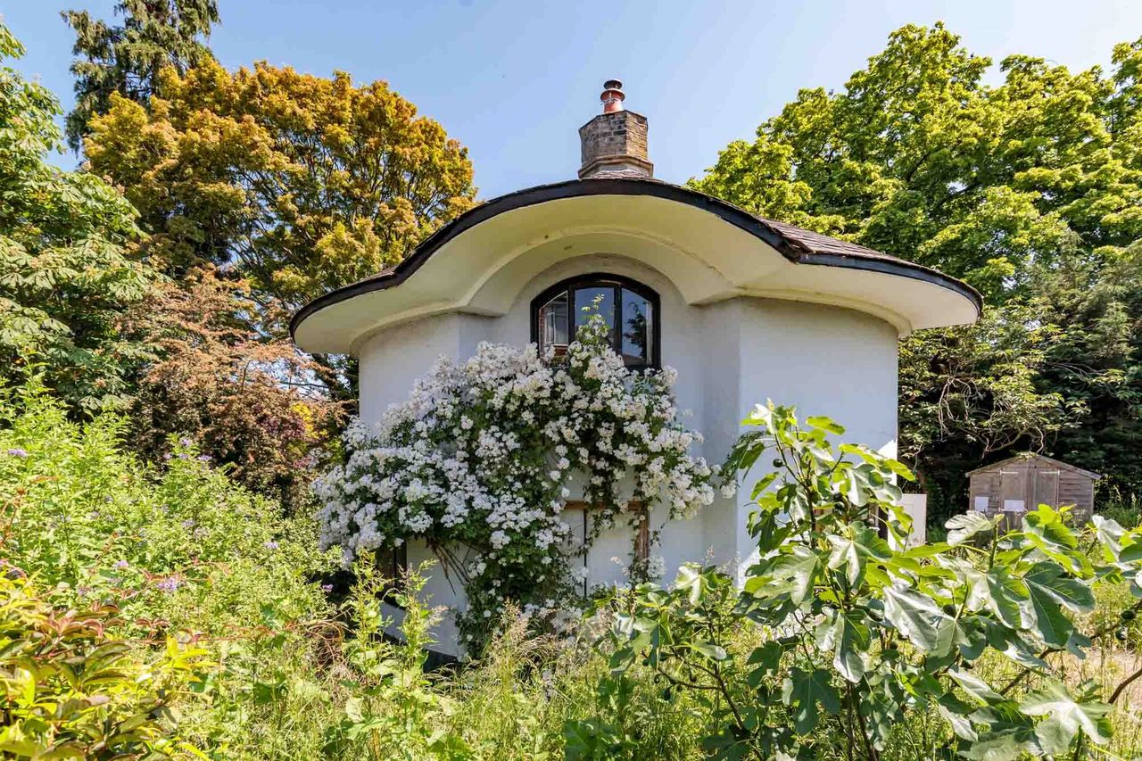 The home is round with flowers running up the side of the house
