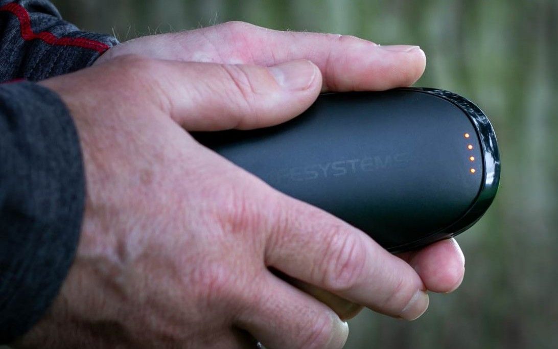 Hands holding Lifesystems Hand Warmer XT