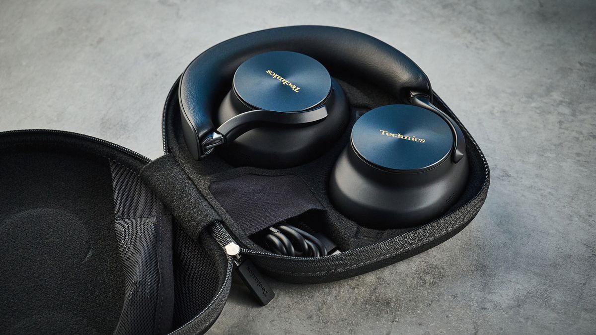 the technics eah-a1000 headphones with a gold technics logo photographed against a blue background