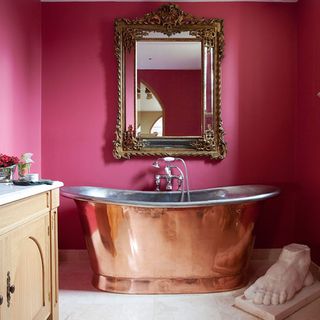 bathroom with pink wall and mirror