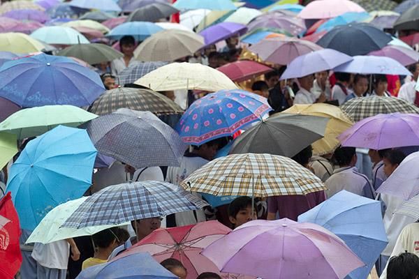Umbrellas were the order of the day as heavy rains again saturated the Tour of Hainan, this time in Danzhou.