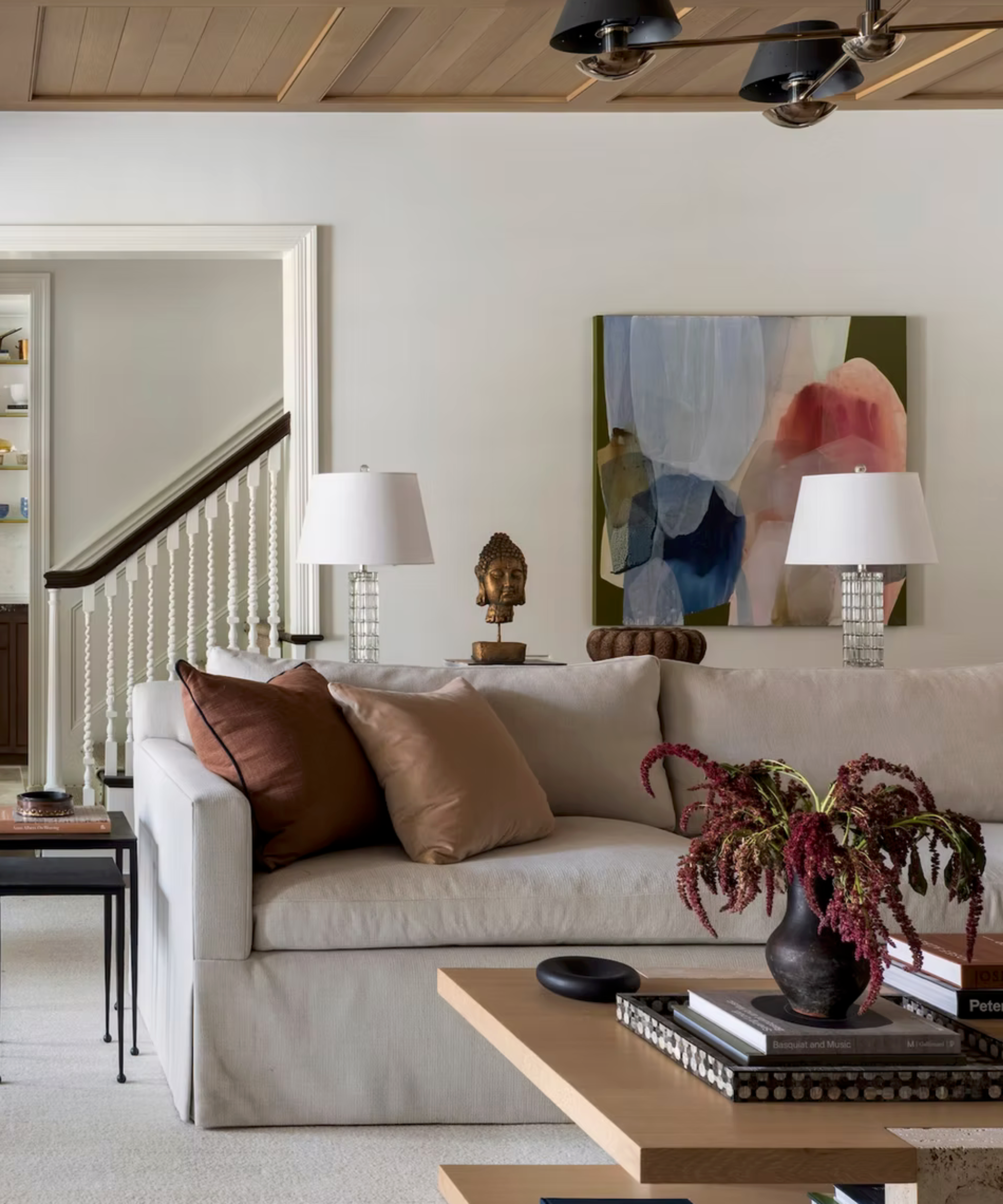 White sofa in small living room with painting