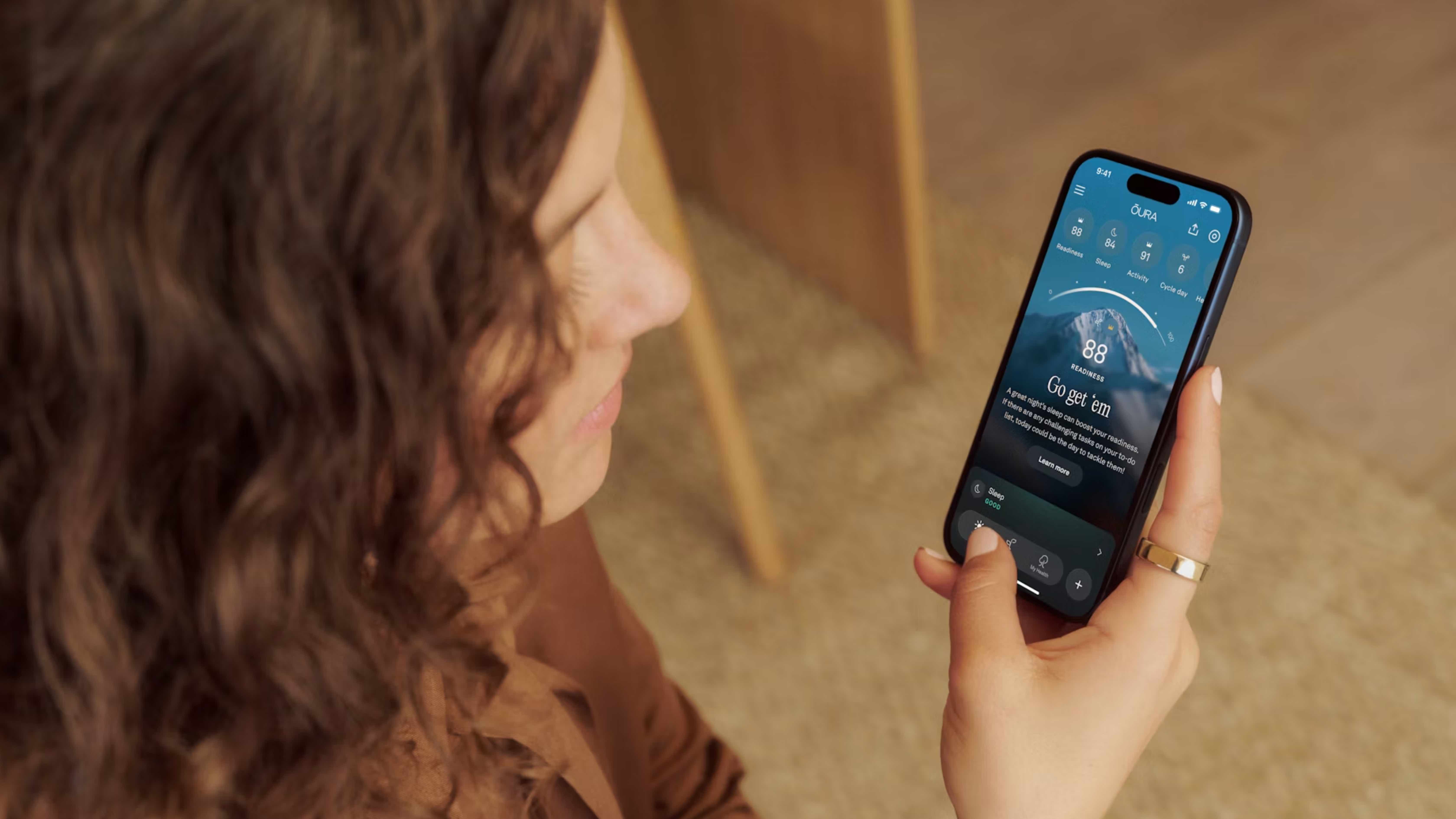 The Oura Ring 5 and companion app in lifestyle images.