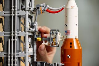 In addition to rebuilding the rocket, the Lego Icons NASA Artemis Space Launch System also builds a launch platform with retracting umbilicals and a crew access arm.