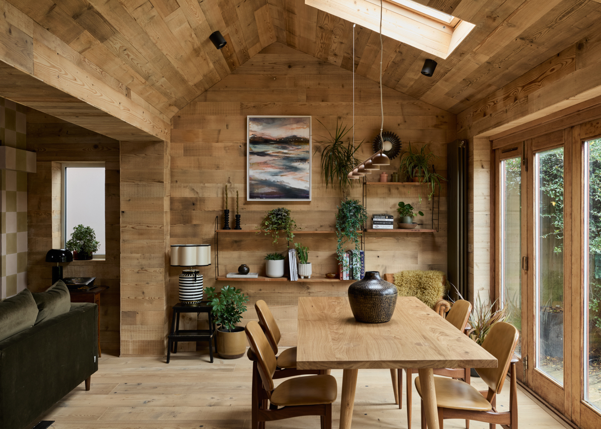 wooden clad home with wooden dining table and lots of natural light