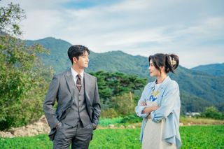 Kang Tae-oh and Lee Sun-bin standing on a picture-esque hillside in in 'The Potato Lab.'