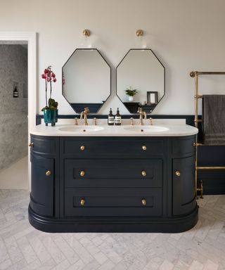 ensuite bathroom with twin vanity unit panted in dark blue with marble tiled floor