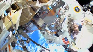 In a view from NASA astronaut Michael Hopkins’ high definition helmet camera, NASA astronaut Victor Glover is seen working outside the International Space Station on a spacewalk on Saturday, March 13, 2021.