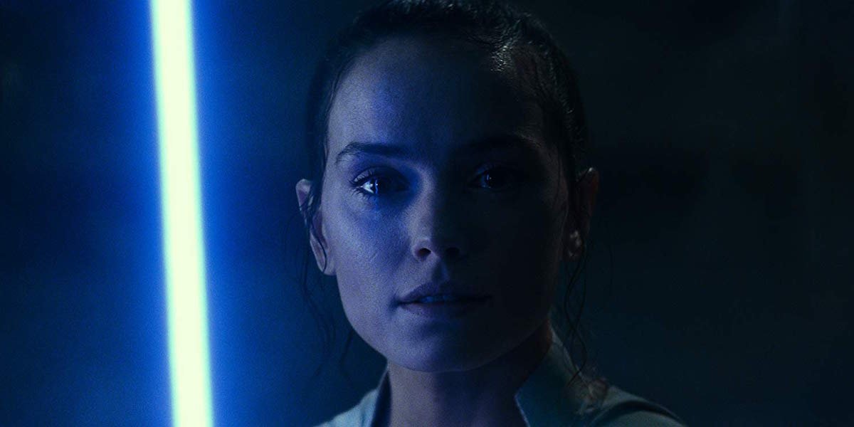 Daisy Ridley as Rey holding lightsaber in Star Wars: The Rise of Skywalker