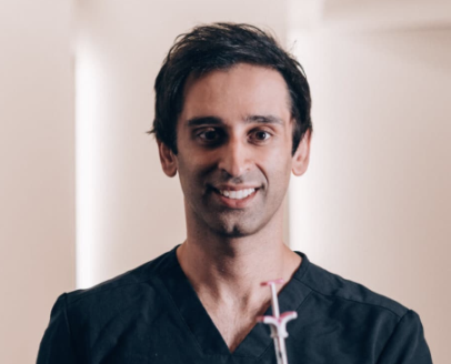 Dr. Bhanusali headshot in navy blue scrubs