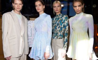 Models wear creme blazer, light blue dress, floral blue top and creme trousers, and yellow and white dress