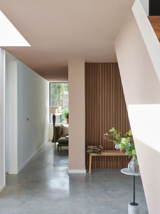 Oak panelling and bench against pink wall
