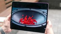 The Apple iPad Pro 2024's OLED screen displaying small red balls. 