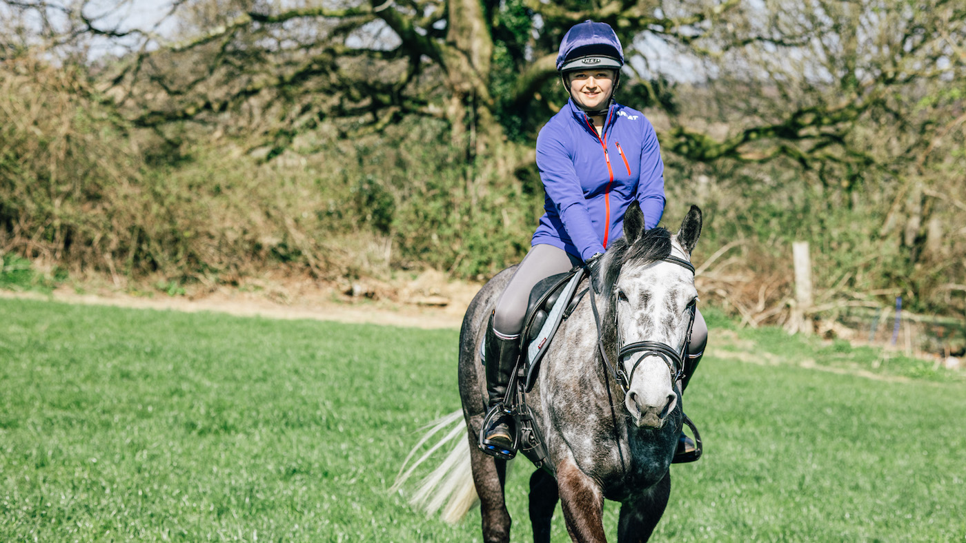 Rider smiling on grey horse