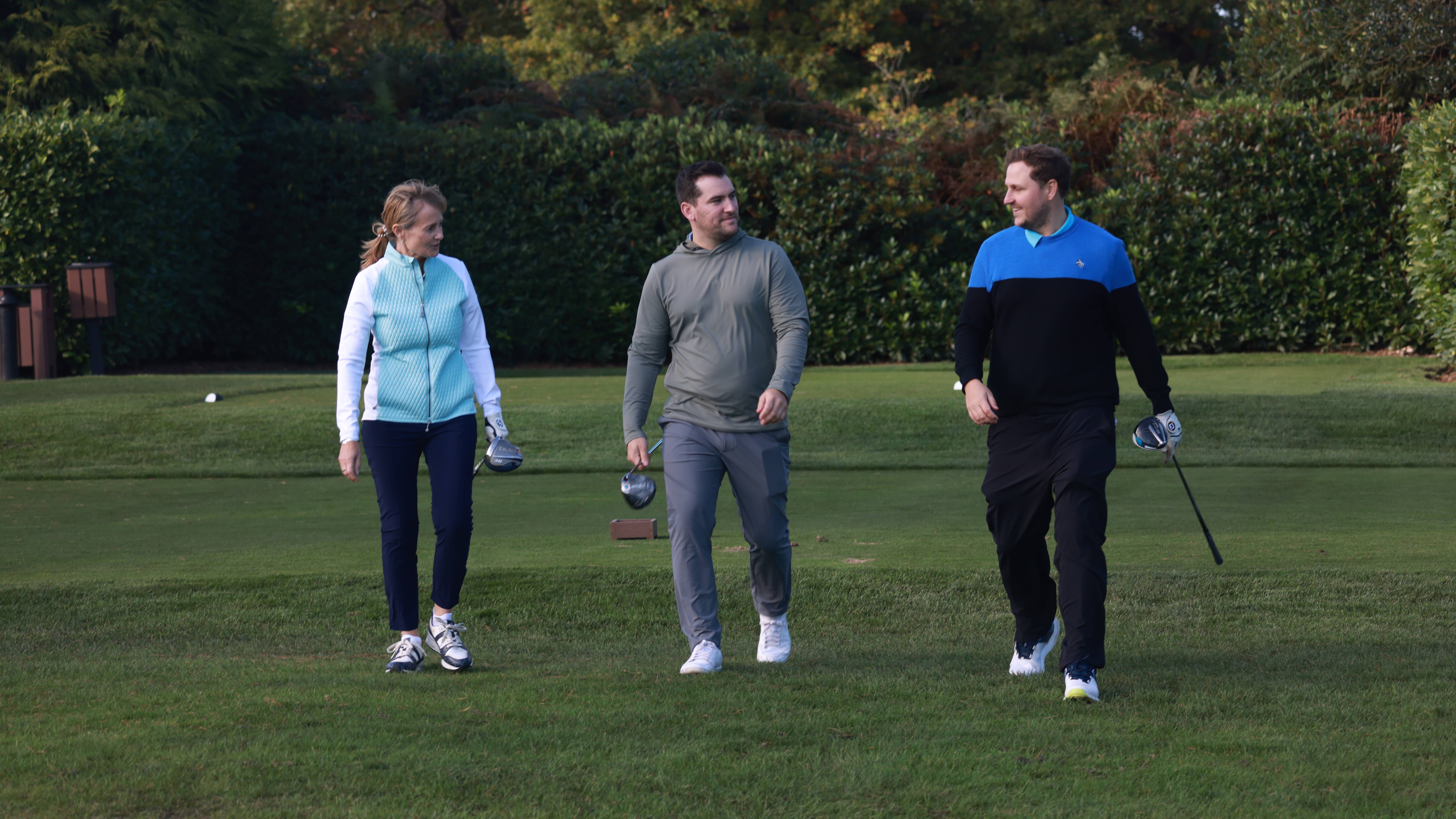 Mixed group of golfers walking off the tee