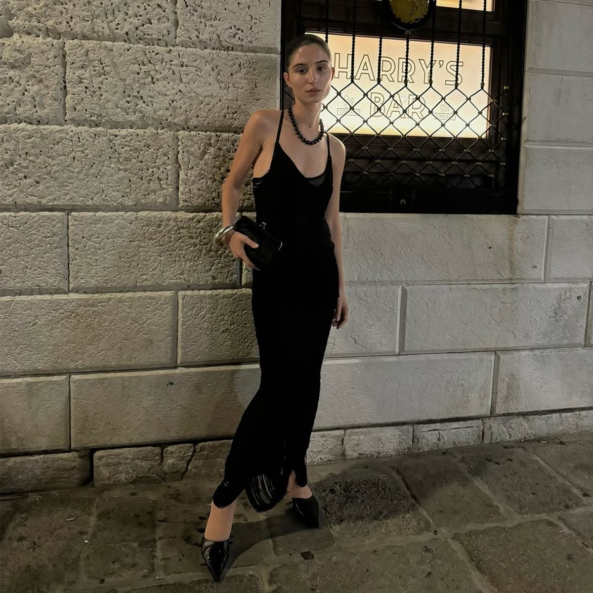 Andrea Ricci wearing a black dress. 
