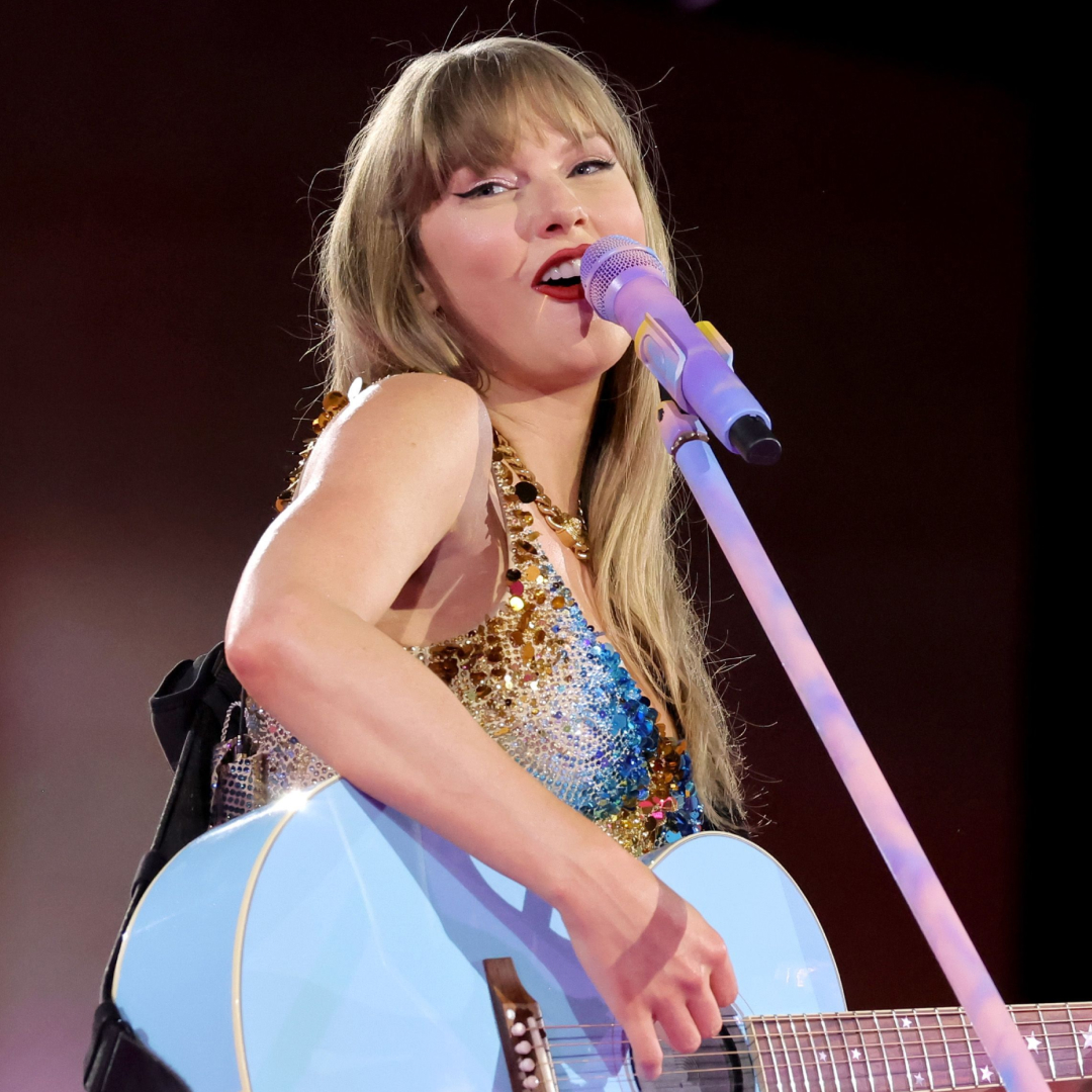 Taylor Swift onstage at the Eras Tour wearing a Versace bodysuit