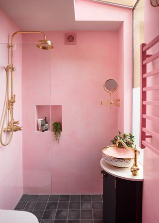 Pink shower room with plaster effect walls and Brass fittings