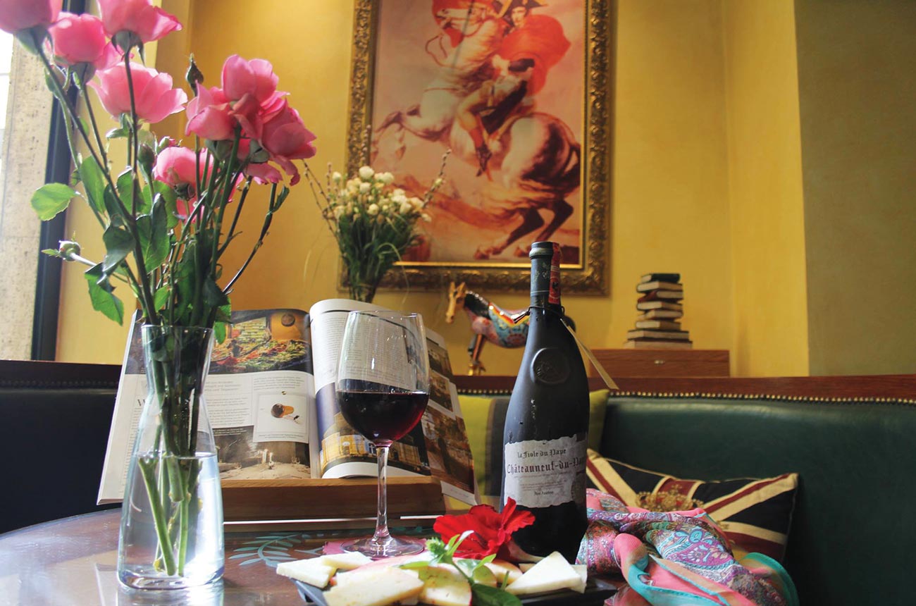 Red wine and cheese in front of a portrait of Napoleon