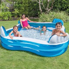 garden with inflatable blue pool with children
