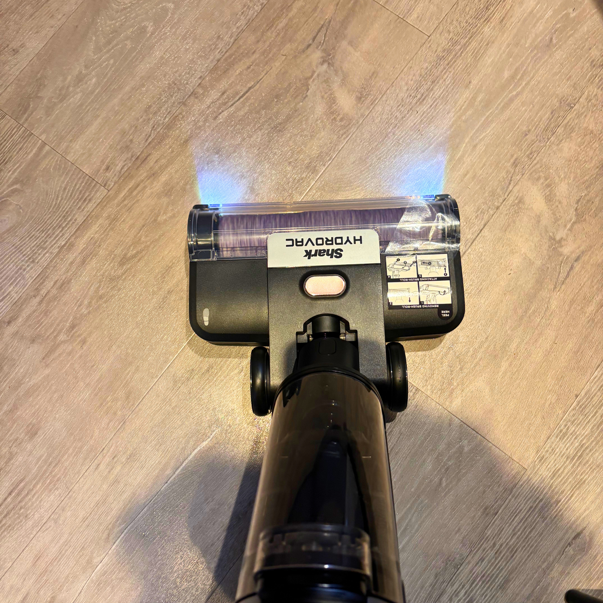 Shark HydroVac Cordless Floor Cleaner on hard floor with illuminated lights
