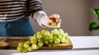 Chopping board with grapes