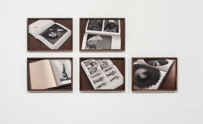 View of Parallel Catalogue by Assaf Hinden - five black and white prints in brown frames against a grey background