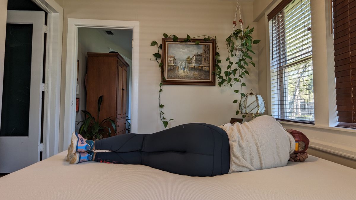 Our tester lying on the Essentia Stratami organic mattress to test its comfort and support