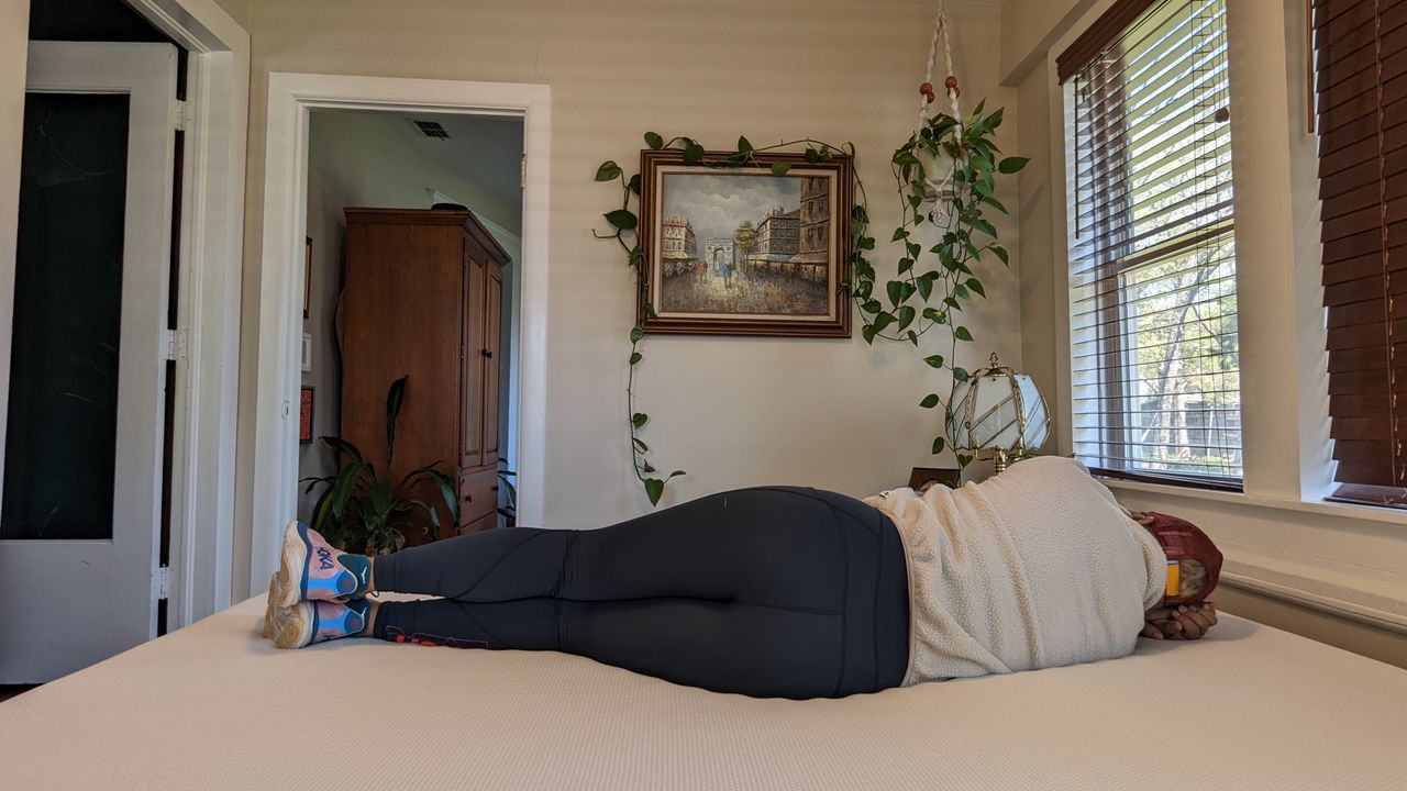 Our tester lying on the Essentia Stratami organic mattress to test its comfort and support