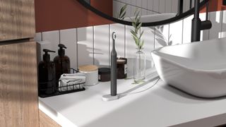 Suri electric toothbrush standing on a bathroom countertop