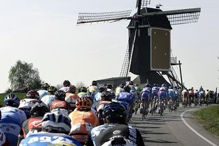 Riders heading towards a windmill.