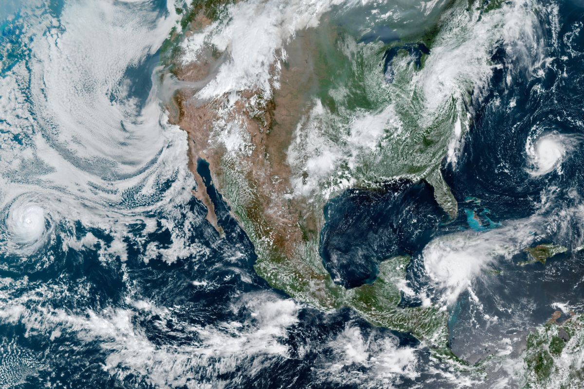 North America is surrounded by 4 storms and wildfire smoke in this satellite vie..