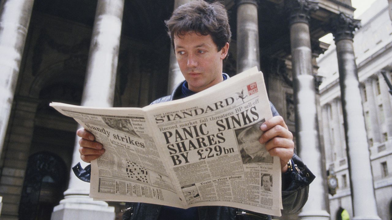 Man reading a paper on &amp;quot;Black Monday&amp;quot; in 1987