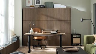 home office with wooden cupboards behind desk and chair