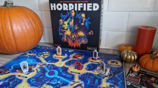 Horrified board game with pumpkins, tokens, and candles