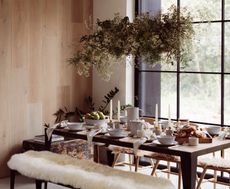 rustic dining table with candles and foliage
