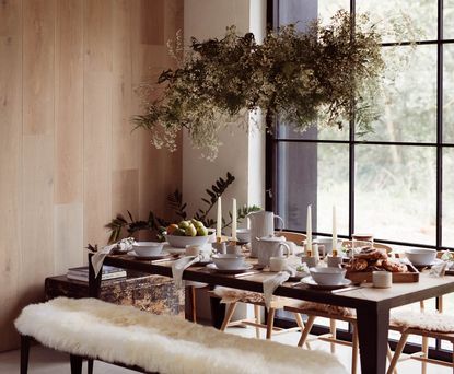 rustic dining table with candles and foliage