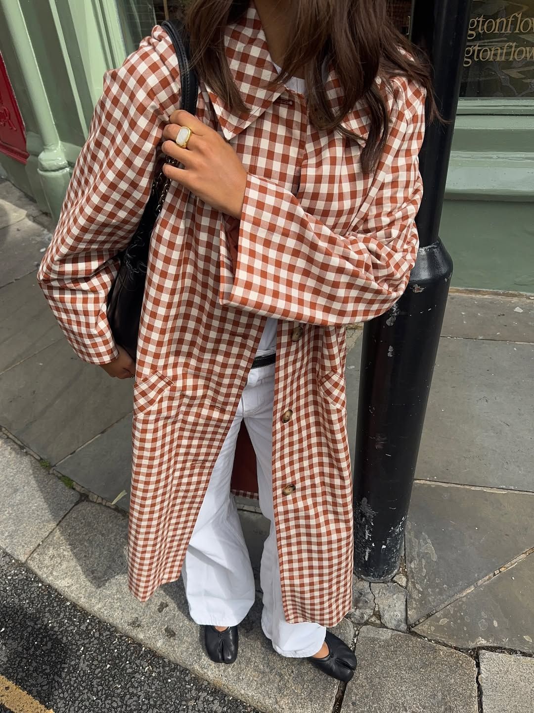 Tia Dewitt wearing a checked trench coat