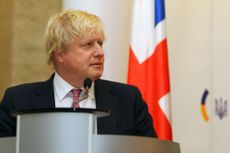 The UK prime minister Boris Johnson standing by a lecturn