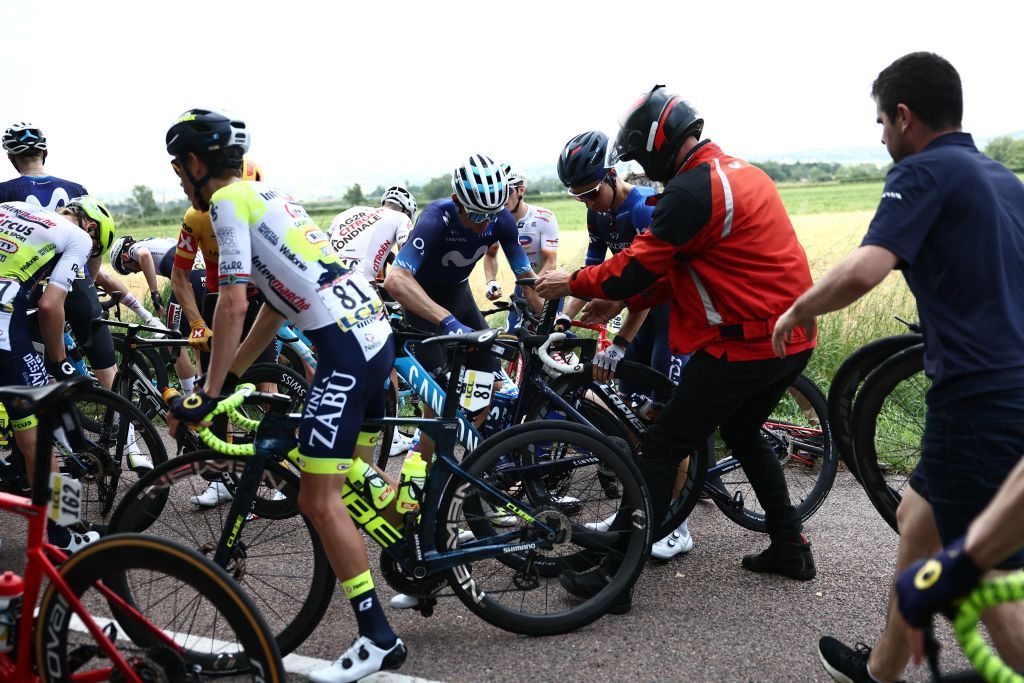 Riders check their bike after a crash in the pack during the third stage of the 75th edition of the Criterium du Dauphine cycling race 1945 kms between MonistrolSurLoire and Le Coteau centraleastern France on June 6 2023 Photo by AnneChristine POUJOULAT AFP Photo by ANNECHRISTINE POUJOULATAFP via Getty Images