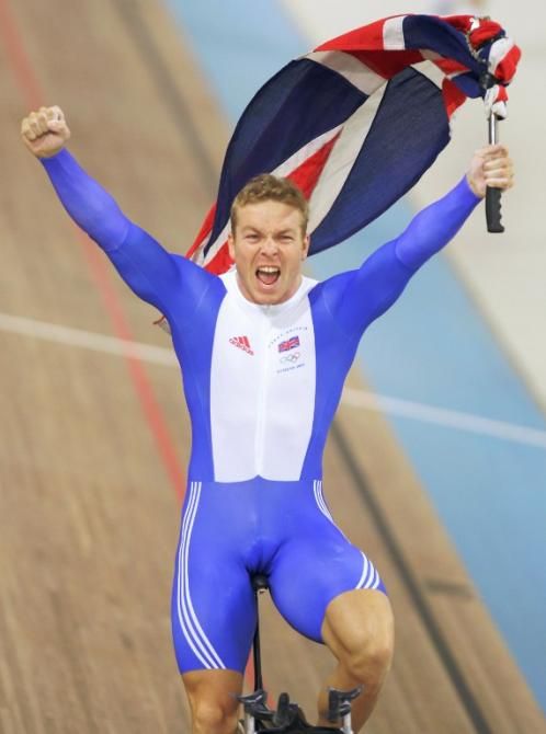 Chris Hoy celebrates after winning the men's 1 km time trial final at the Athens velodrome