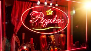 Neon &quot;psychic&quot; sign in a shop window.