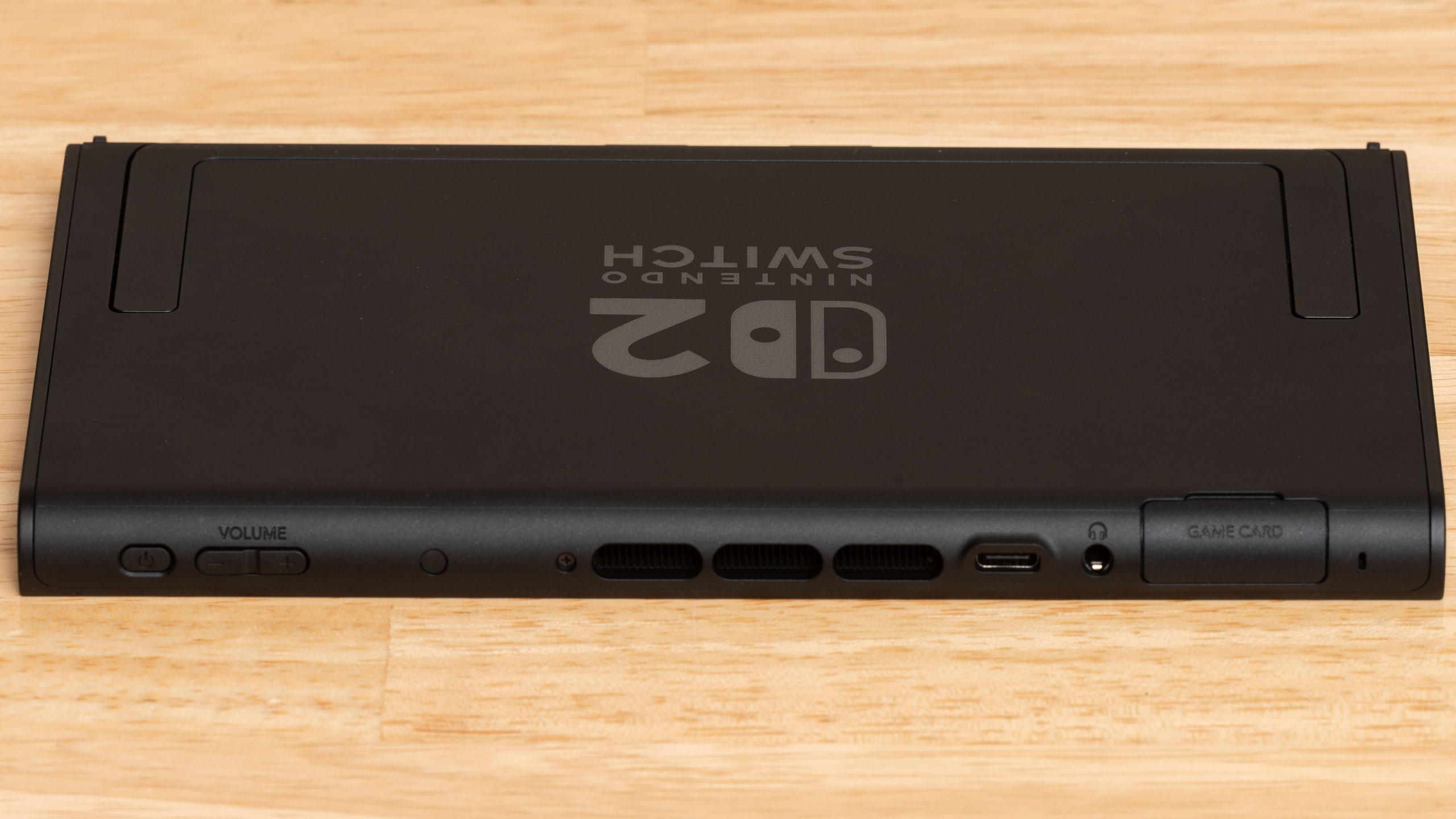 The top edge of a Nintendo Switch 2 console, showing its buttons, ports, and vents