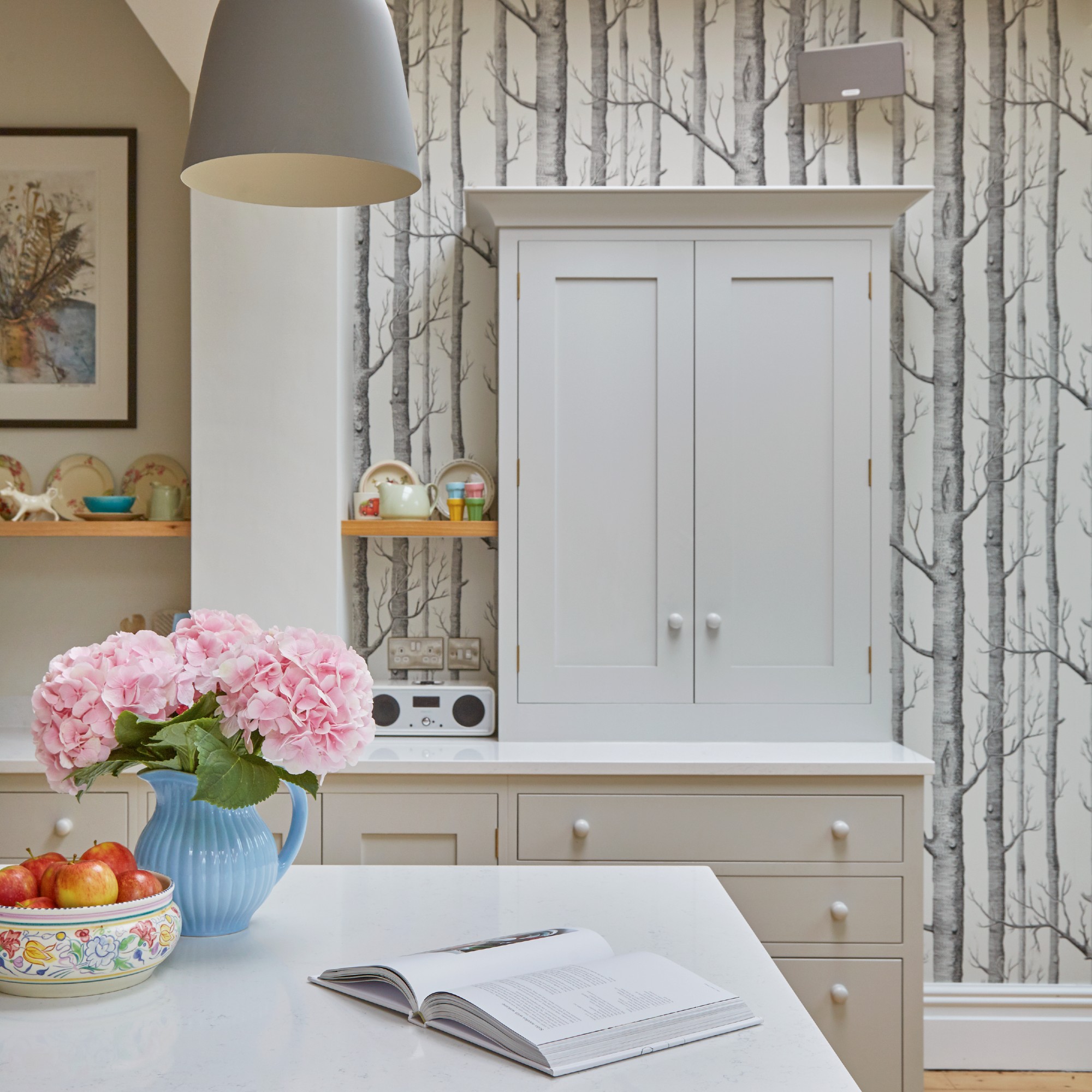 A kitchen with a feature wallpaper wall